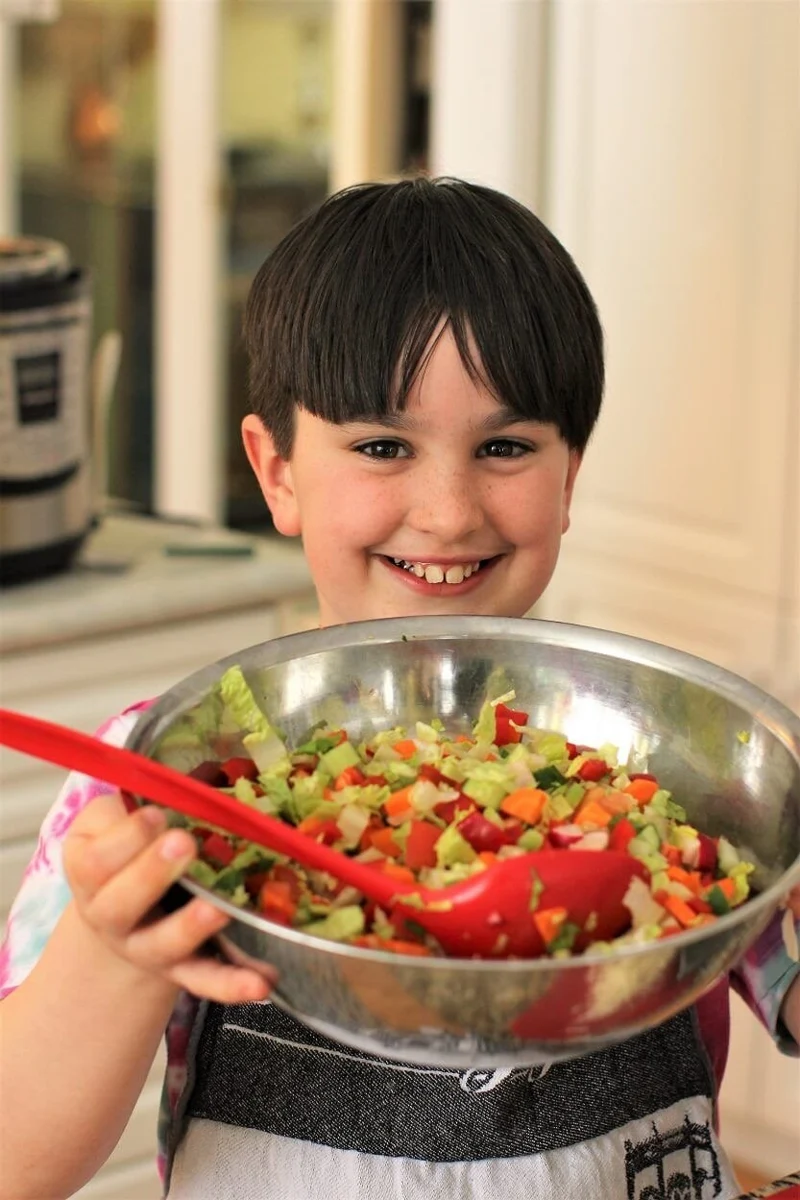 A child sharing a colourful food creation